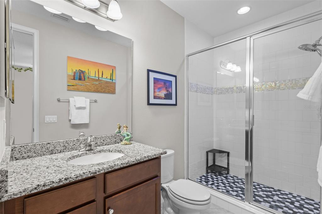 14822 Trails Edge Boulevard Odessa, FL 33556 - Photo 38 of 73 a bathroom with a granite countertop sink toilet and shower