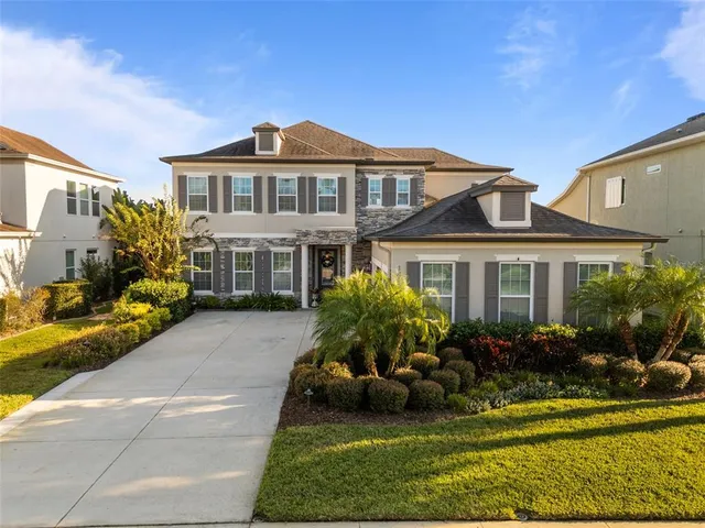 a view of swimming pool with outdoor seating and house in the background