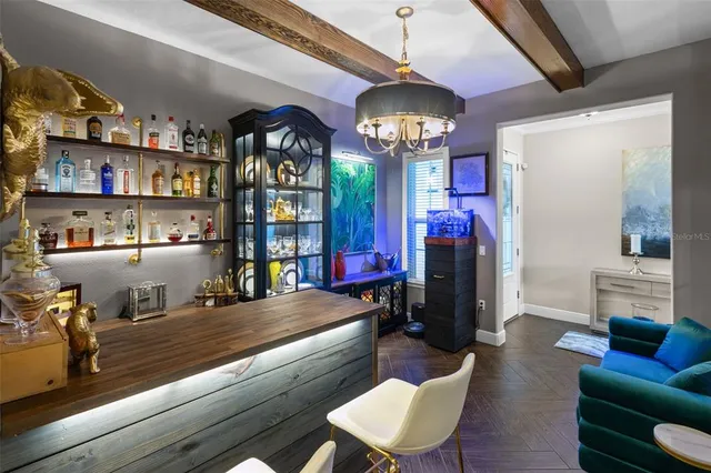 a view of a dining room with furniture and chandelier