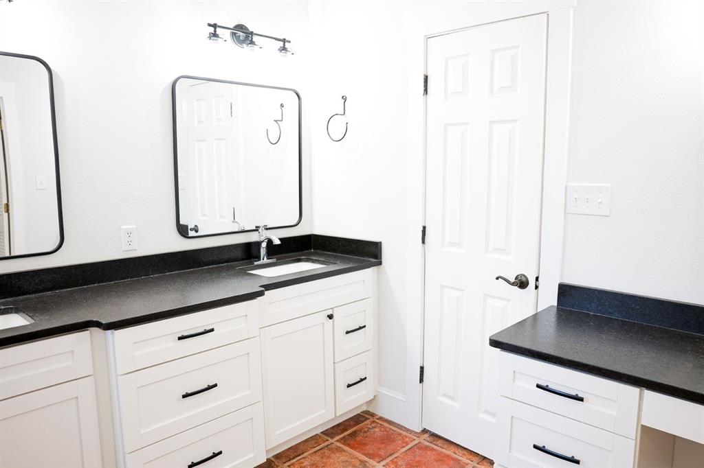 10575 Friendship Road Pilot Point, TX 76258 - Photo 29 of 32 Bathroom featuring a dual vanity with white shaker-style cabinetry and dark countertops