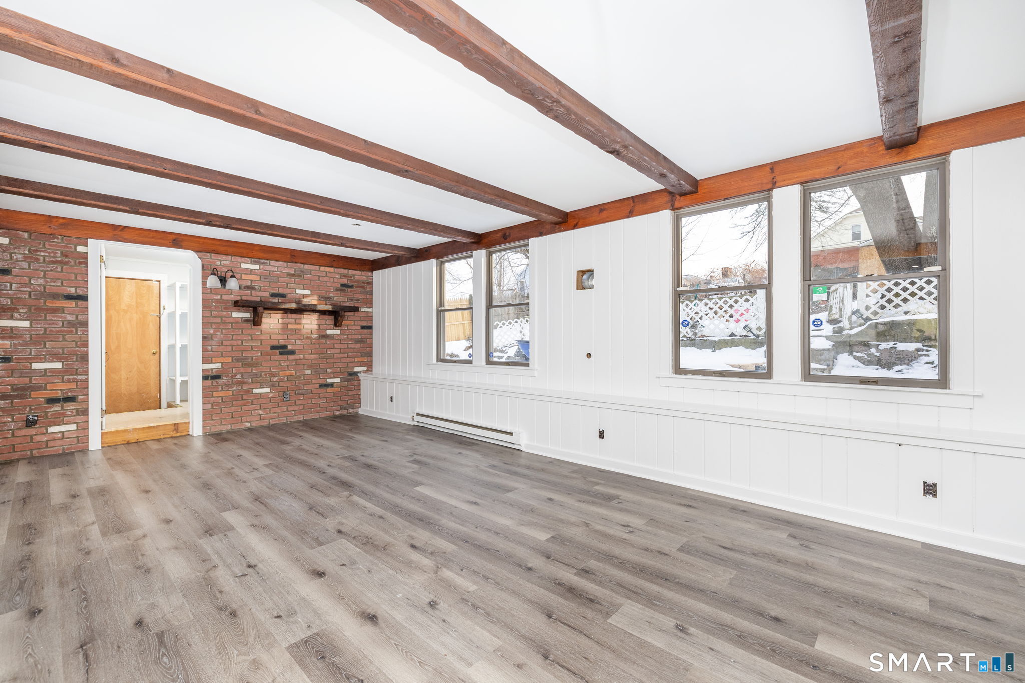 153 Gridley Street Bristol, CT 06010 - Photo 11 of 14 a view of an empty room with a window and wooden floor