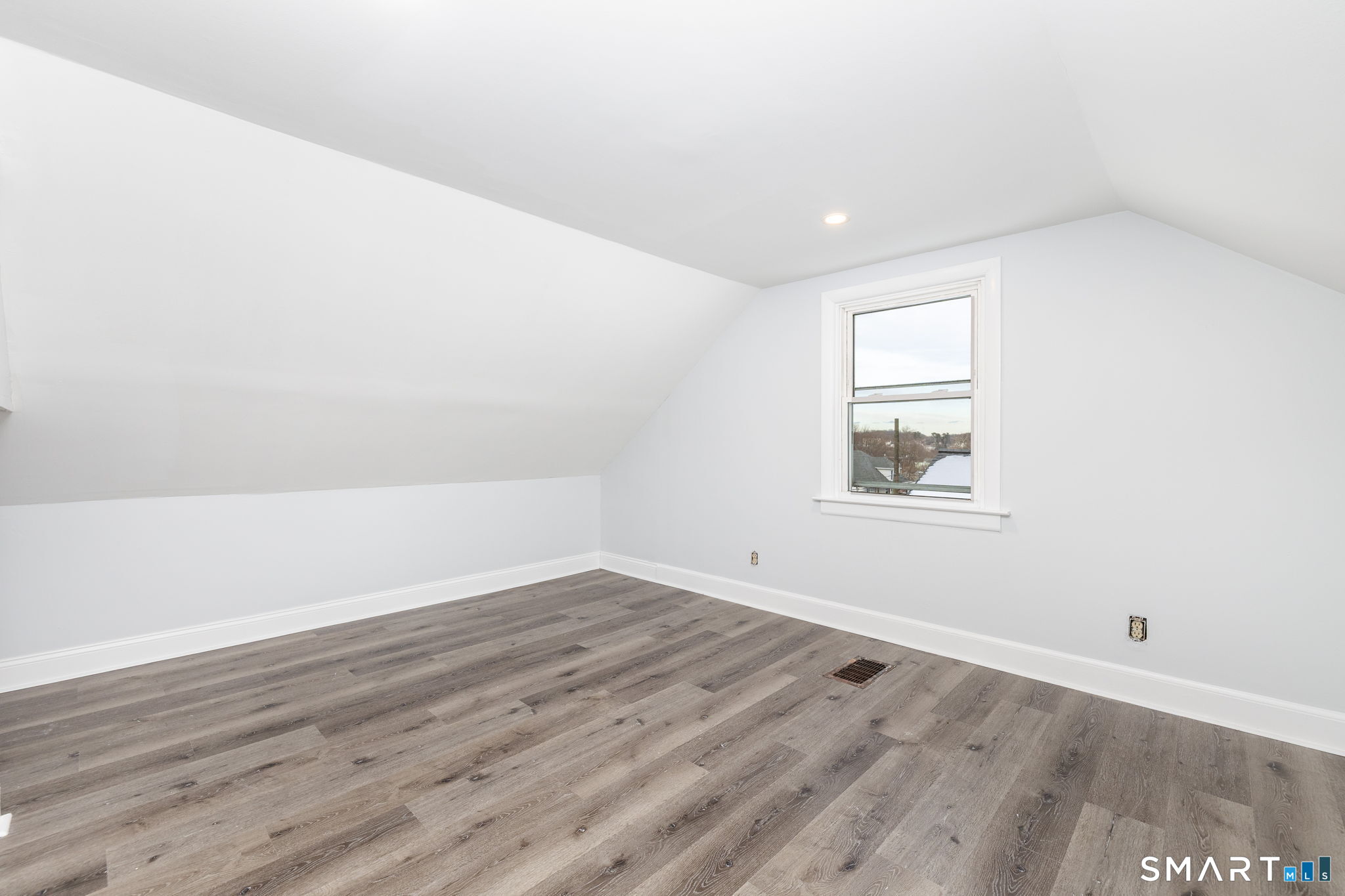 153 Gridley Street Bristol, CT 06010 - Photo 14 of 14 an empty room with wooden floor and windows