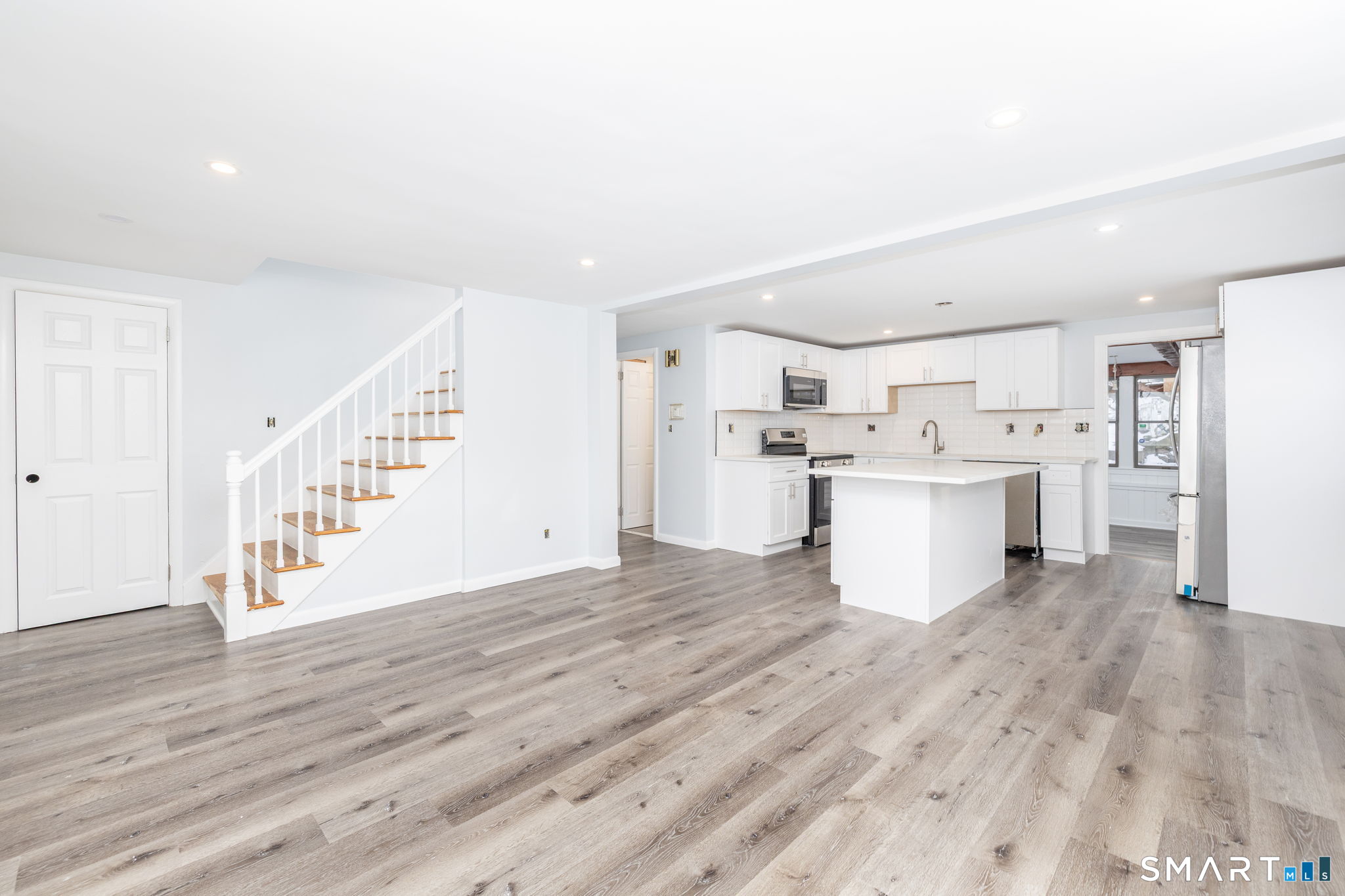 153 Gridley Street Bristol, CT 06010 - Photo 4 of 14 a view of a kitchen with wooden floor and electronic appliances