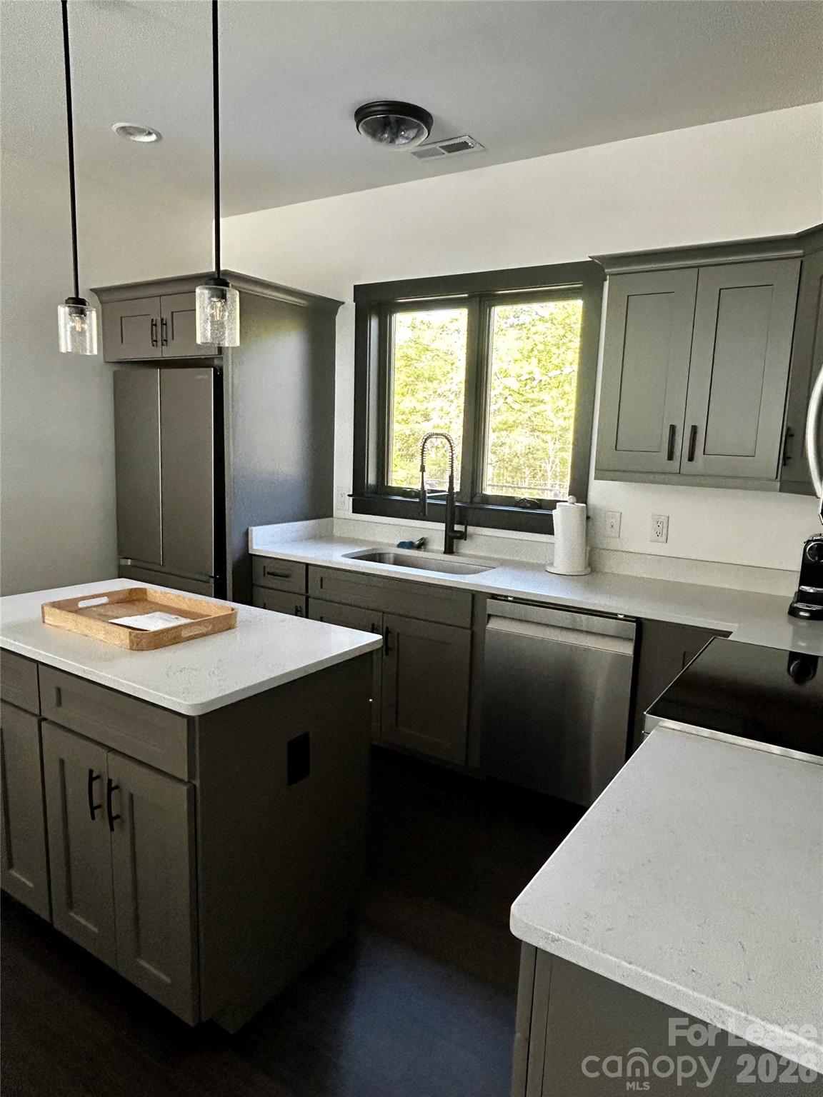 23 Shoals Falls Road Hendersonville, NC 28739 - Photo 4 of 13 a kitchen with a sink a counter top space and a window