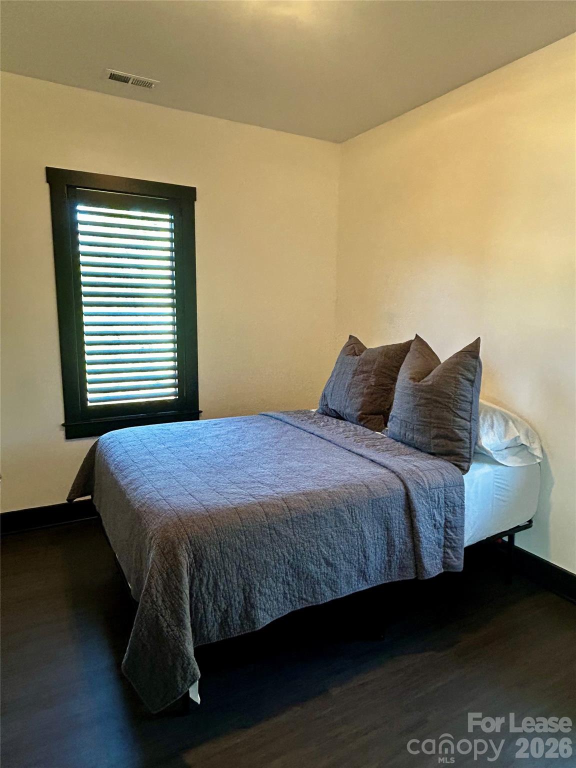 23 Shoals Falls Road Hendersonville, NC 28739 - Photo 7 of 13 a bed sitting in a bedroom next to a window