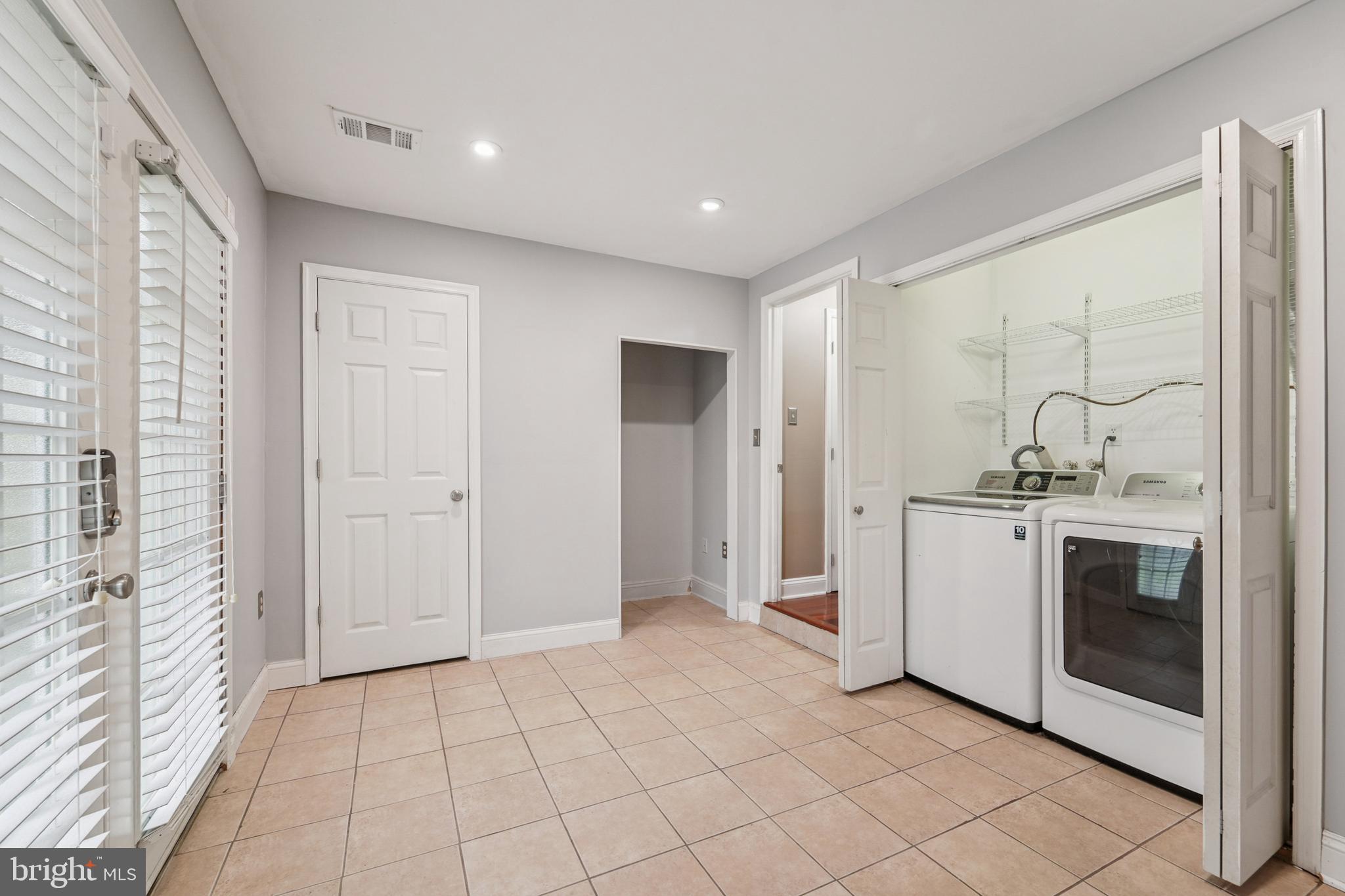56 Victoria Square Frederick, MD 21702 - Photo 26 of 38 a view of a hallway with washer and dryer