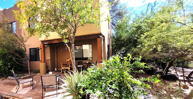 a view of house with yard and sitting area