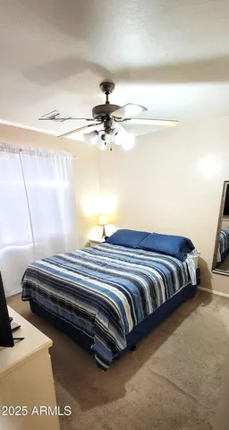 a bedroom with a bed and lamp