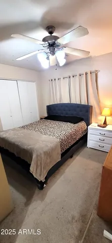 a bedroom with bed and window