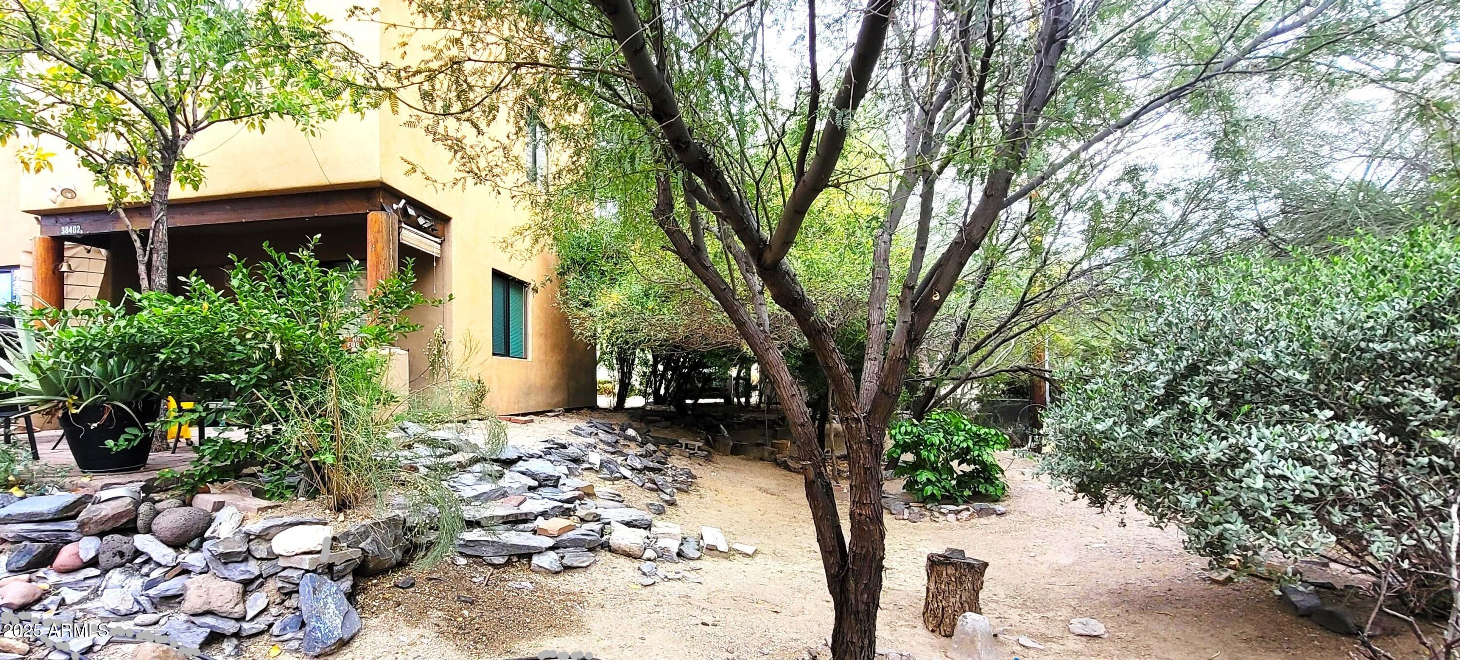 38402 North Basin Road, Unit B Cave Creek, AZ 85331 - Photo 18 of 19 a pathway of a house with a yard