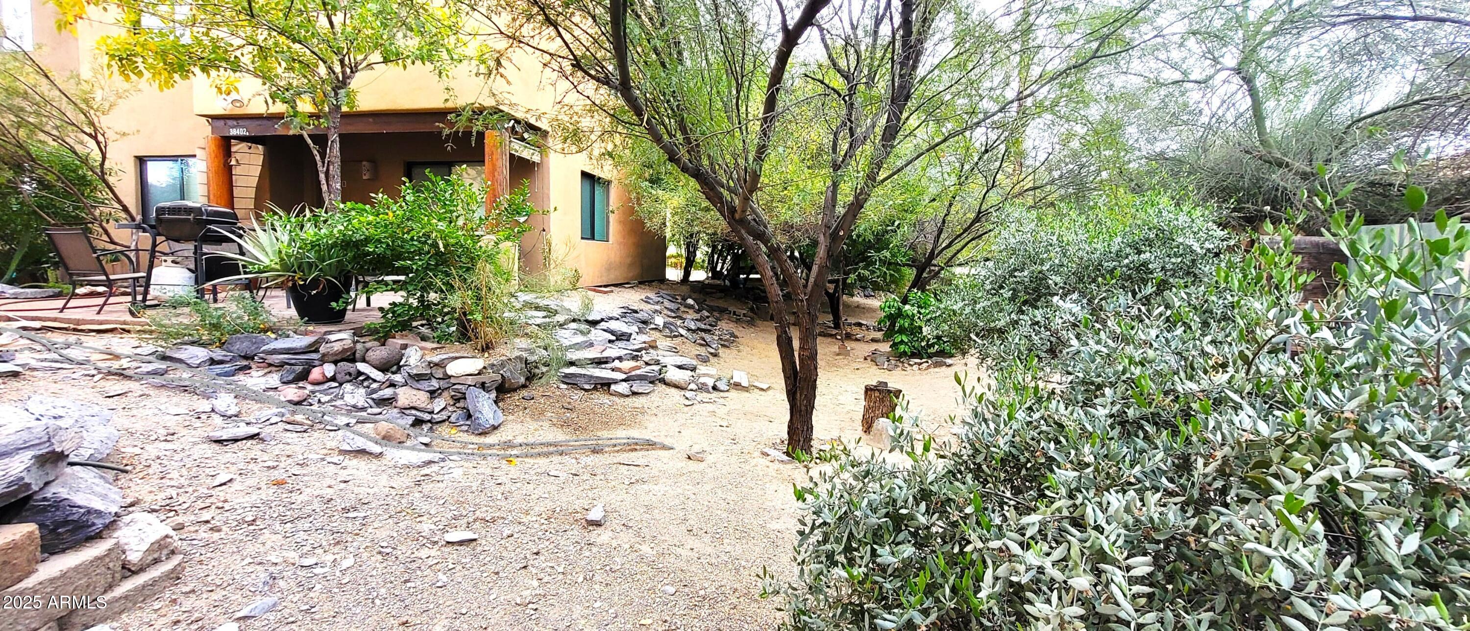 38402 North Basin Road, Unit B Cave Creek, AZ 85331 - Photo 19 of 19 a front view of a house with a yard