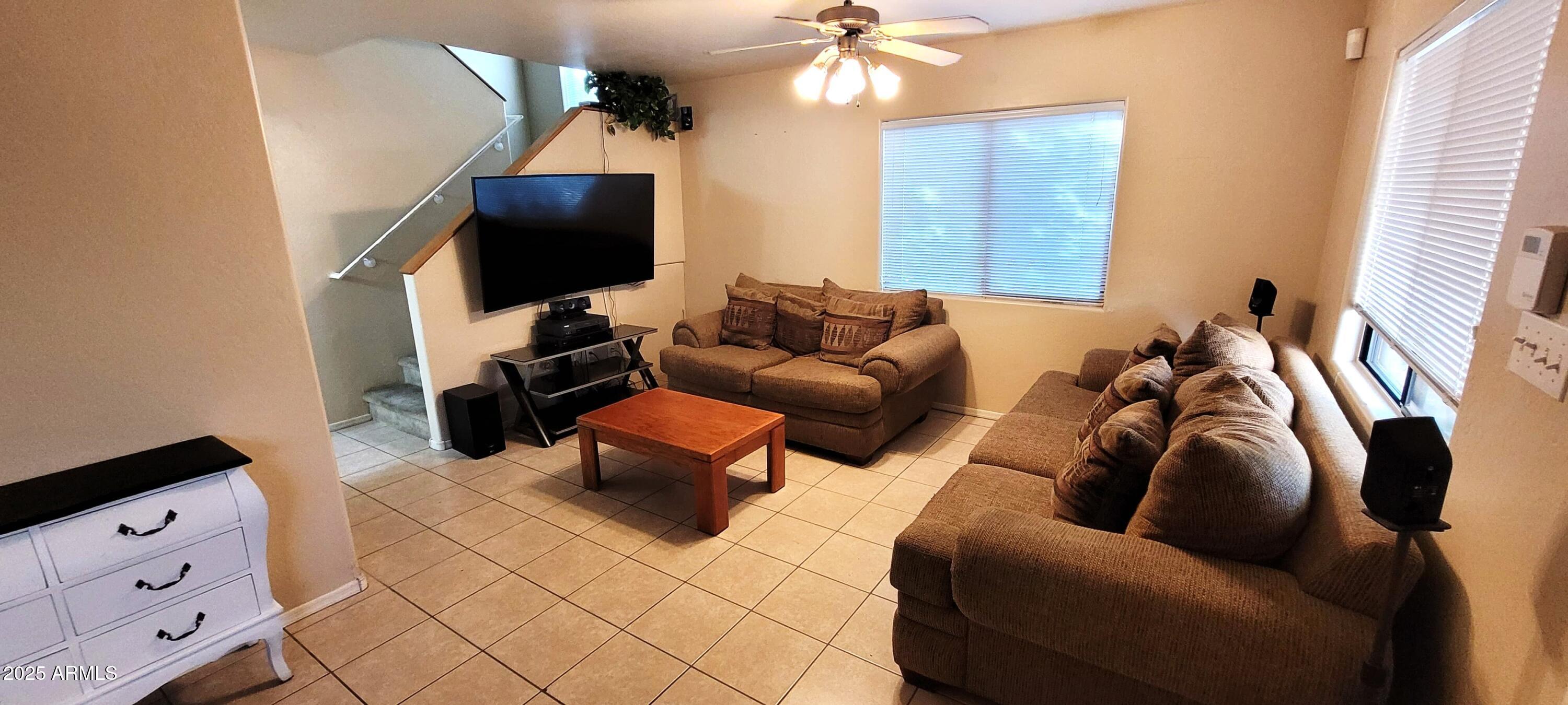 38402 North Basin Road, Unit B Cave Creek, AZ 85331 - Photo 5 of 19 a living room with furniture and a flat screen tv