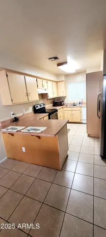 a kitchen with stainless steel appliances granite countertop a sink and white cabinets
