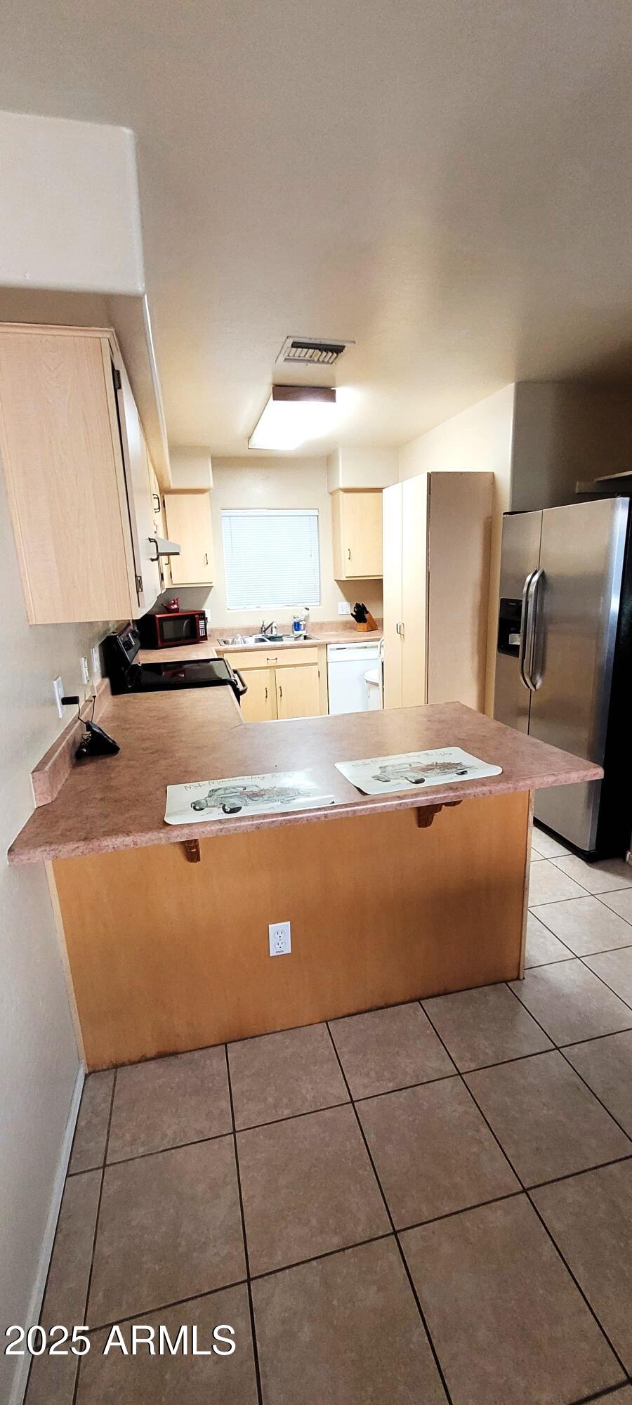 38402 North Basin Road, Unit B Cave Creek, AZ 85331 - Photo 7 of 19 a kitchen with stainless steel appliances granite countertop a sink and a stove