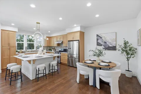 a open kitchen with stainless steel appliances granite countertop a stove and a sink