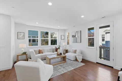 a living room with furniture kitchen view and a dining table