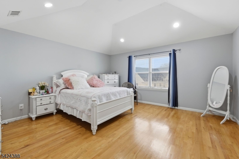 433 Linden Avenue Elizabeth, NJ 07202 - Photo 12 of 33 a bedroom with a bed and wooden floor