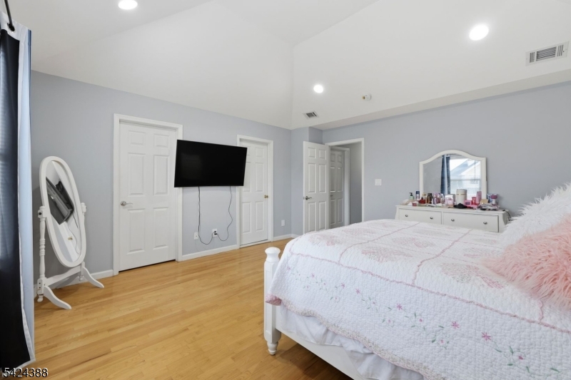 433 Linden Avenue Elizabeth, NJ 07202 - Photo 13 of 33 a bedroom with a bed tv and a bathroom