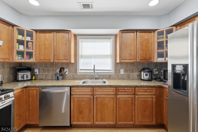 433 Linden Avenue Elizabeth, NJ 07202 - Photo 19 of 33 a kitchen with stainless steel appliances granite countertop a sink a stove and a refrigerator