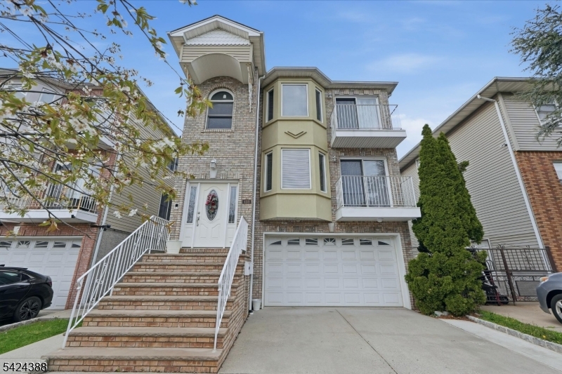 433 Linden Avenue Elizabeth, NJ 07202 - Photo 2 of 33 a front view of a house with a yard