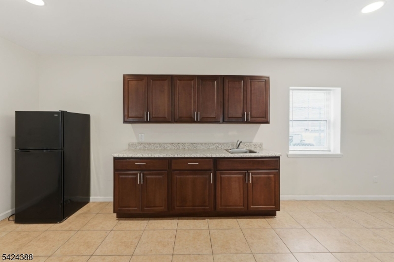 433 Linden Avenue Elizabeth, NJ 07202 - Photo 28 of 33 a kitchen with a cabinets and a stove top oven