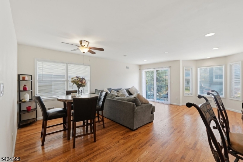 433 Linden Avenue Elizabeth, NJ 07202 - Photo 29 of 33 a living room with furniture a floor to ceiling window and wooden floor