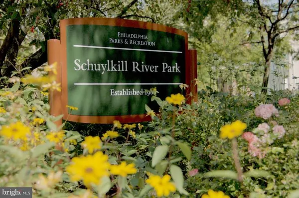 a sign that is sitting in front of flowers