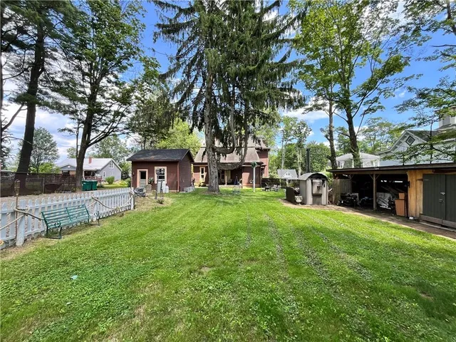 a view of a house with a yard porch and sitting area