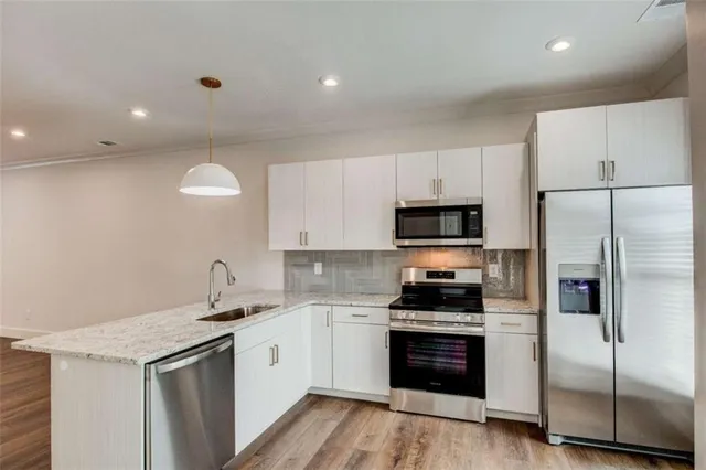 a kitchen with granite countertop a sink and cabinets