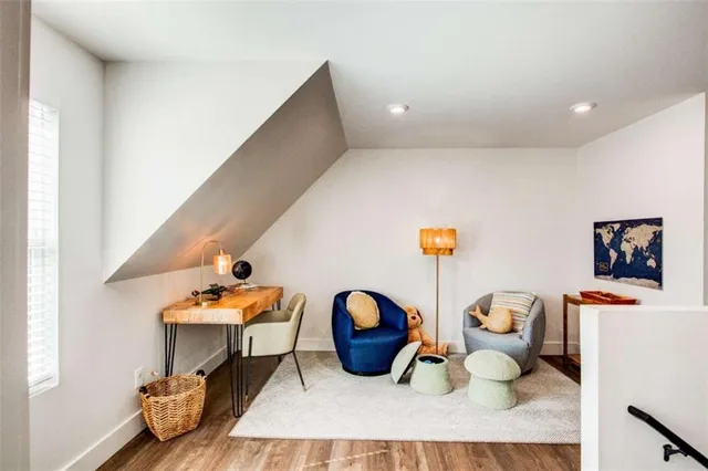 a living room with furniture a rug and a large window