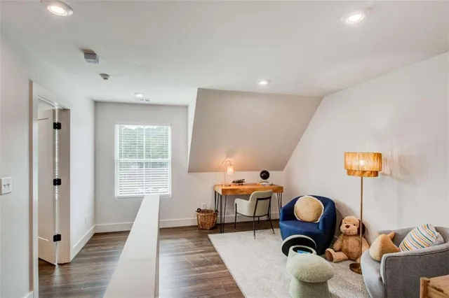 a hallway with wooden floor and furniture
