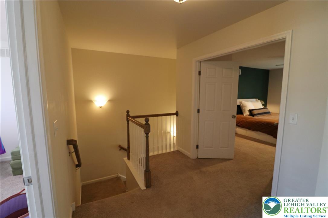 4502 Benjamin Court Emmaus, PA 18049 - Photo 22 of 53 A warm overhead light illuminates the carpeted landing leading to a comfortable sleeping area.