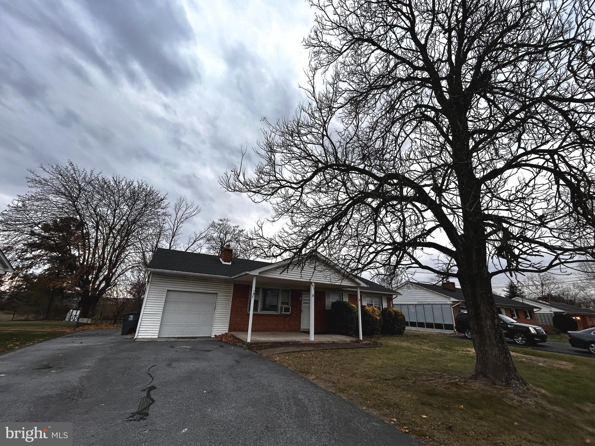 760 Jordan Springs Road Stephenson, VA 22656 - Photo 2 of 27 a front view of a house with a yard and trees