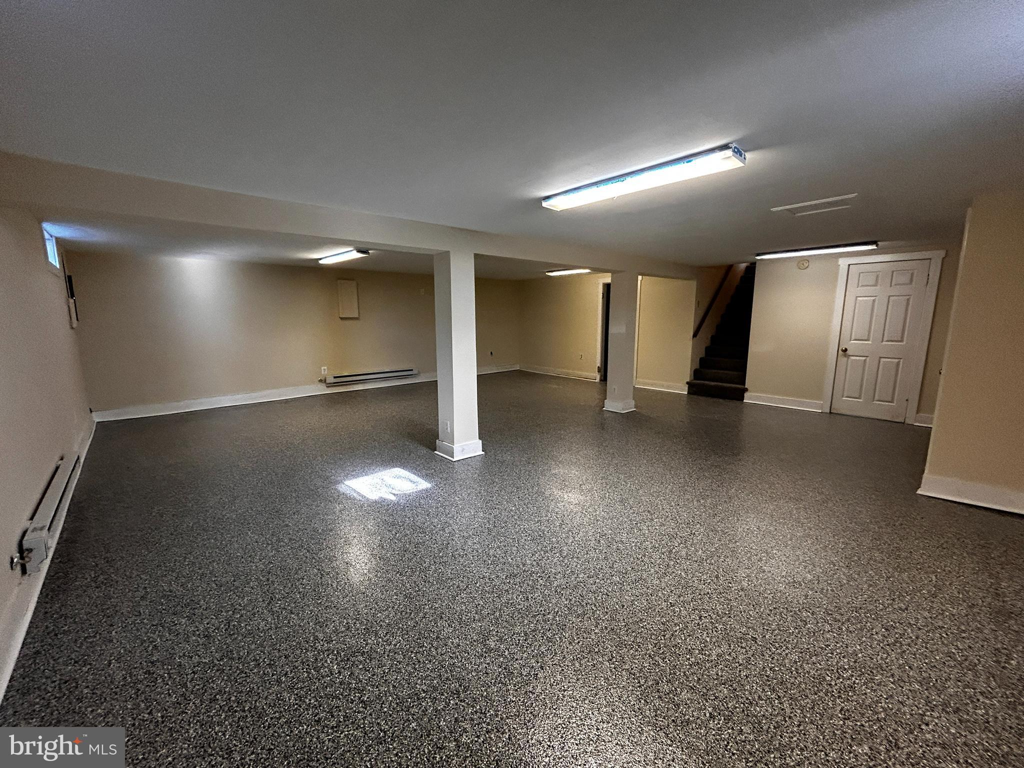 760 Jordan Springs Road Stephenson, VA 22656 - Photo 22 of 27 an empty room with a wooden floor and windows