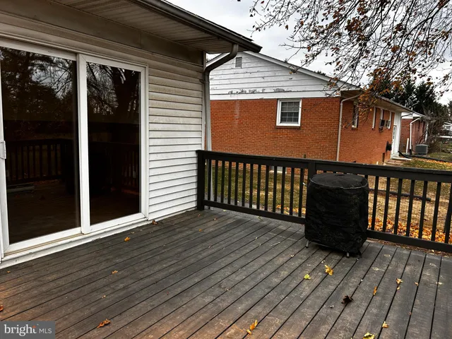 a view of a house with wooden deck