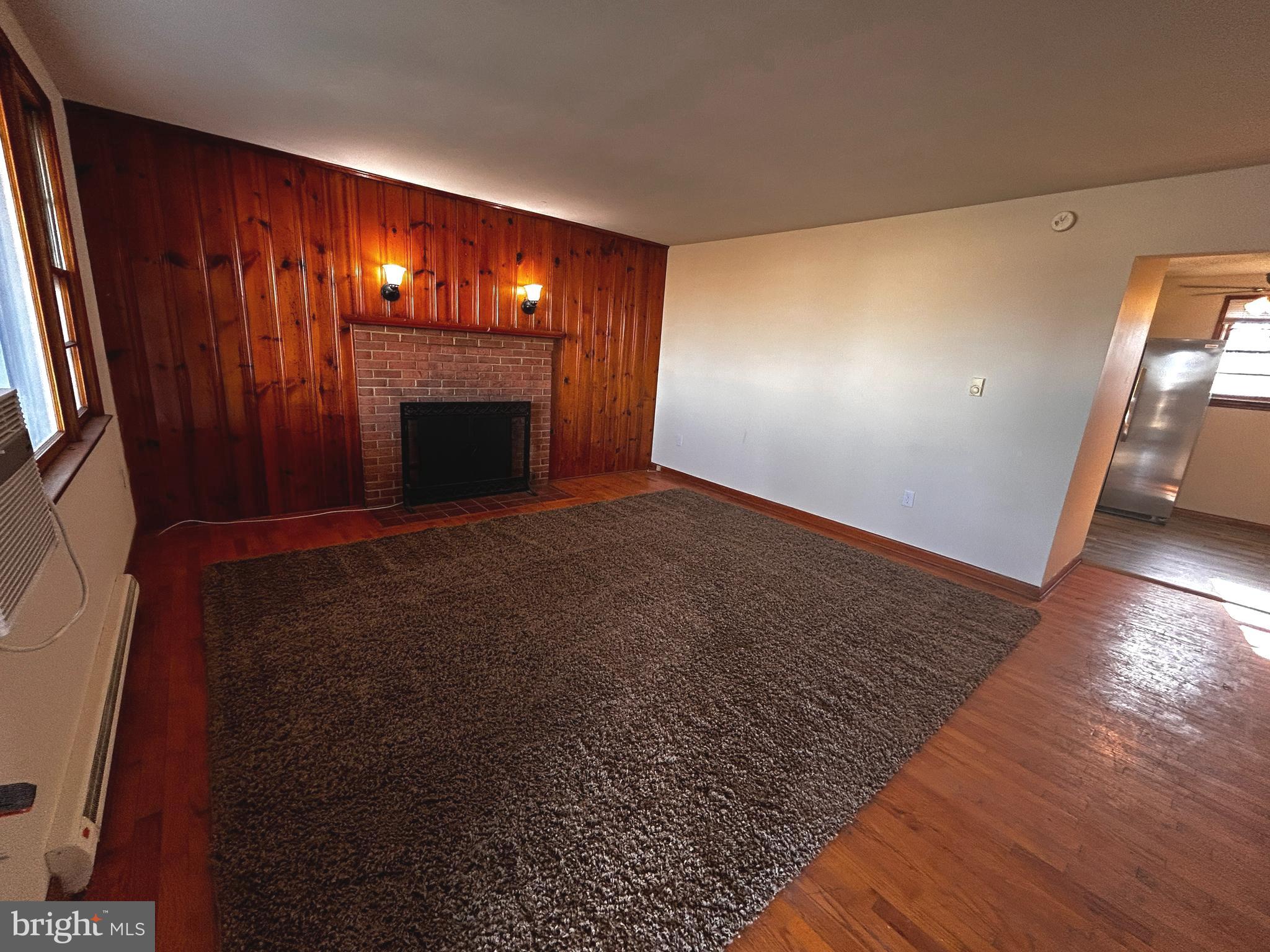 760 Jordan Springs Road Stephenson, VA 22656 - Photo 7 of 27 a view of empty room with wooden floor and fireplace