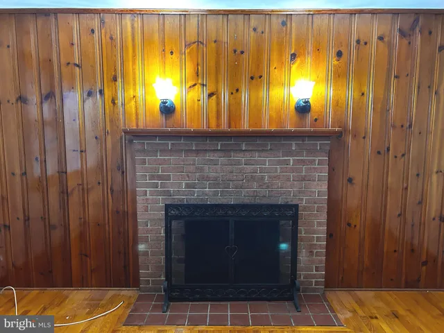 a view of a livingroom with a fireplace and window