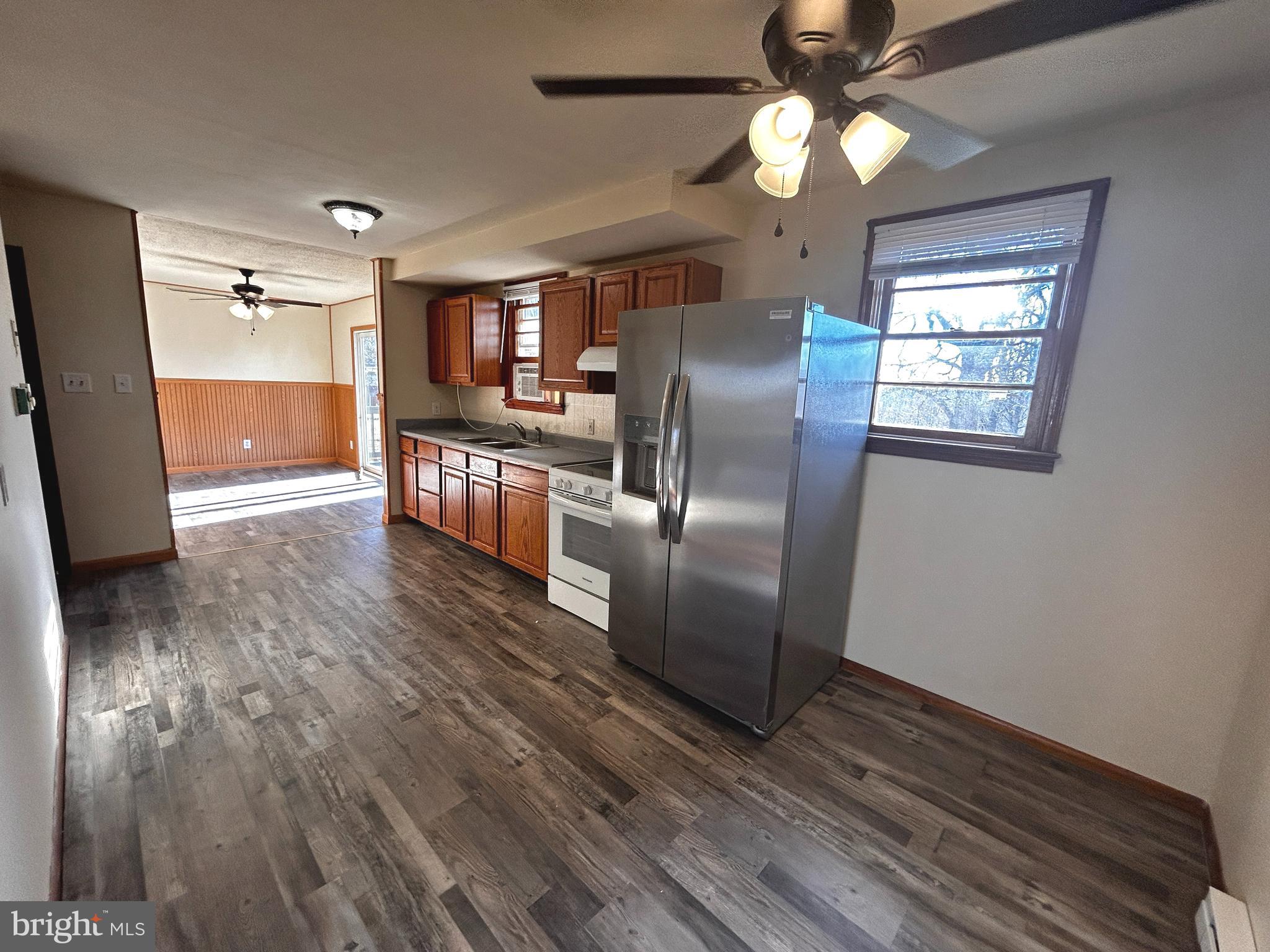760 Jordan Springs Road Stephenson, VA 22656 - Photo 10 of 27 a kitchen with stainless steel appliances granite countertop a refrigerator a stove and a wooden floors
