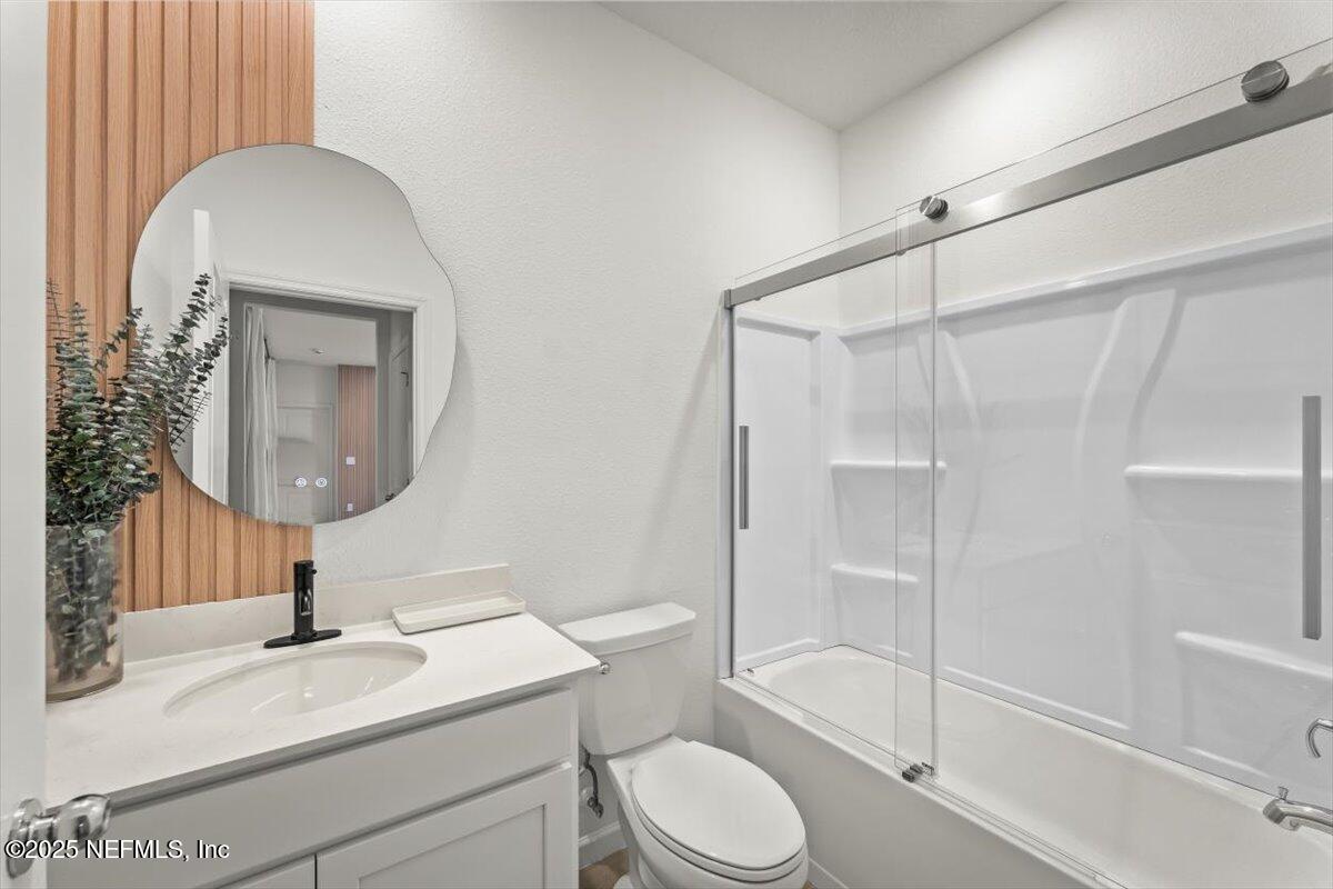 1598 Lachlan Circle Jacksonville, FL 32218 - Photo 23 of 38 a bathroom with a toilet a sink and a mirror