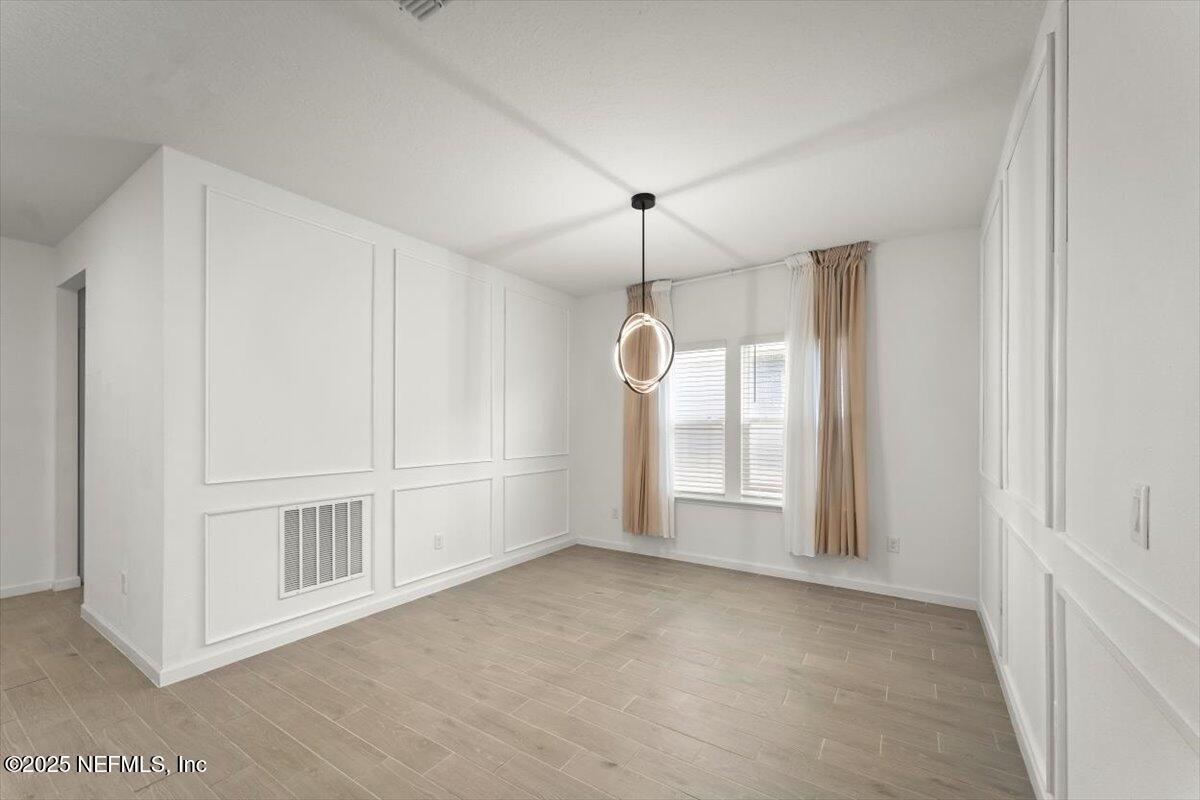 1598 Lachlan Circle Jacksonville, FL 32218 - Photo 25 of 38 an empty room with chandelier fan and windows