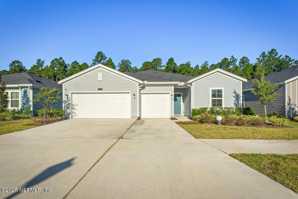 1598 Lachlan Circle Jacksonville, FL 32218 - Photo 3 of 38 a front view of a house with a yard and garage