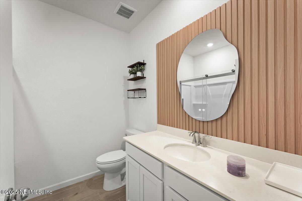 1598 Lachlan Circle Jacksonville, FL 32218 - Photo 34 of 38 a bathroom with a toilet a sink and a mirror