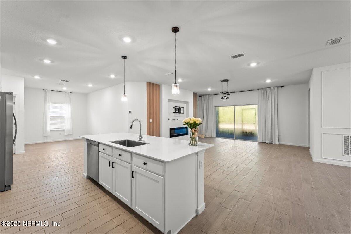 1598 Lachlan Circle Jacksonville, FL 32218 - Photo 6 of 38 a large kitchen with stainless steel appliances kitchen island a large island in the center