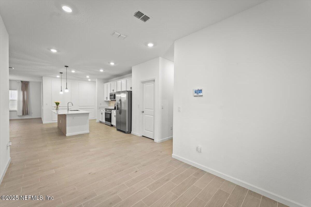 1598 Lachlan Circle Jacksonville, FL 32218 - Photo 9 of 38 a view of an empty room with a refrigerator