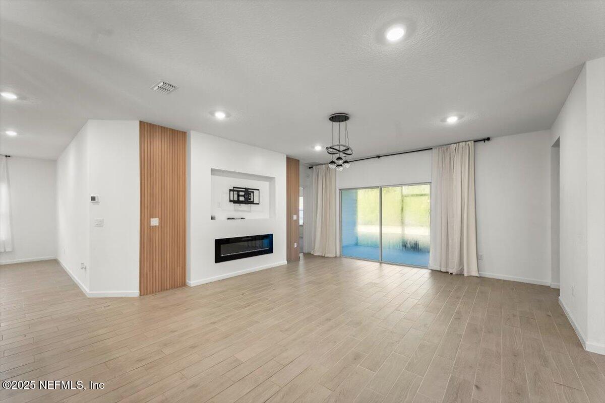 1598 Lachlan Circle Jacksonville, FL 32218 - Photo 10 of 38 an empty room with windows and fireplace