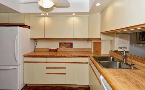 a kitchen with stainless steel appliances a sink stove and refrigerator