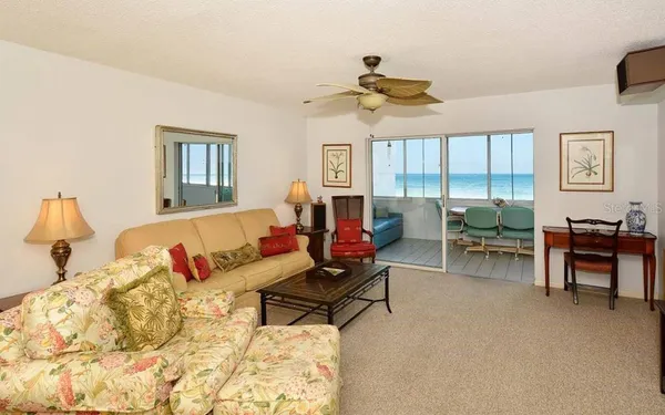 a living room with furniture and a dining table with window