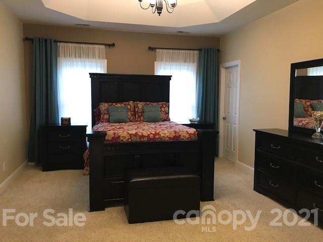 1912 Riverbank Road Waxhaw, NC 28173 - Photo 11 of 19 a bedroom with a bed and a television