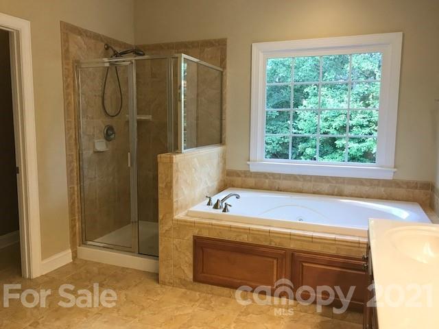 1912 Riverbank Road Waxhaw, NC 28173 - Photo 13 of 19 a bathroom with a bathtub and a shower