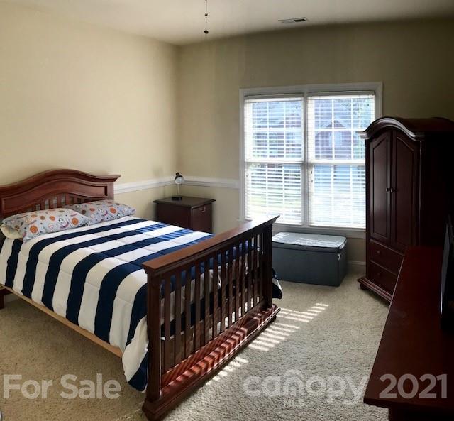 1912 Riverbank Road Waxhaw, NC 28173 - Photo 14 of 19 a bedroom with a bed and wooden floor